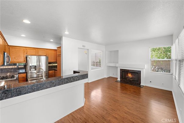 Fireplace, Interior, Kitchen, Recessed Lighting, Stainless Steel Appliances, Wood Texture Flooring