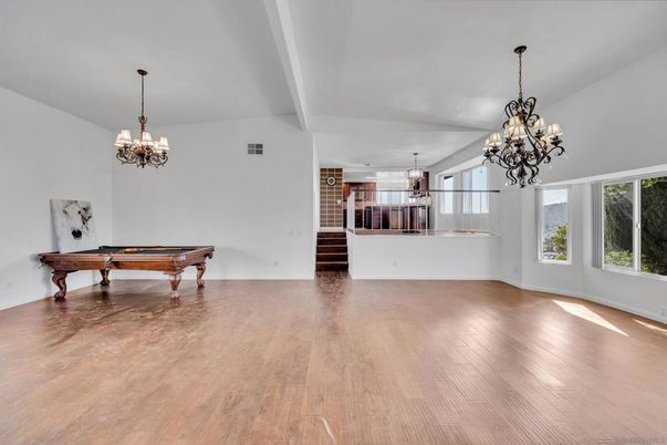 Billiard Table, Chandelier, Empty room, Fireplace, Game Room, Interior, Stone Walls, Wood Texture Flooring