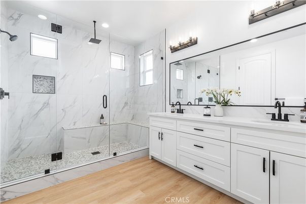 Bathroom, Dual Sink Vanities, Glass Shower, Interior, Marble Walls, Recessed Lighting, Wood Texture Flooring