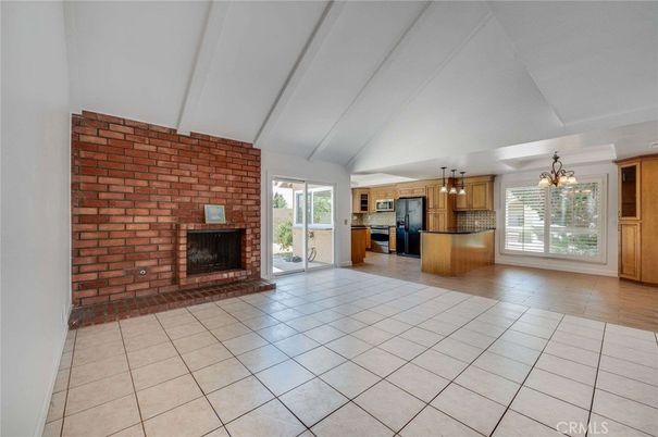 Chandelier, Empty room, Fireplace, Interior, Kitchen, Pendant Lights, Stainless Steel Appliances, Stone Walls