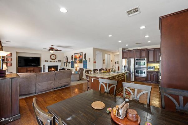 Fireplace, Interior, Kitchen, Living room, Recessed Lighting, Stainless Steel Appliances, Wood Texture Flooring