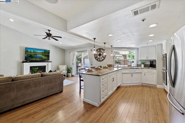 Chandelier, Dining room, Fireplace, Interior, Kitchen, Living room, Pendant Lights, Recessed Lighting, Wood Texture Flooring