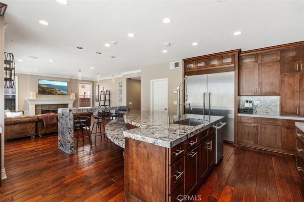 Fireplace, Interior, Kitchen, Living room, Pendant Lights, Recessed Lighting, Stainless Steel Appliances, Wood Texture Flooring
