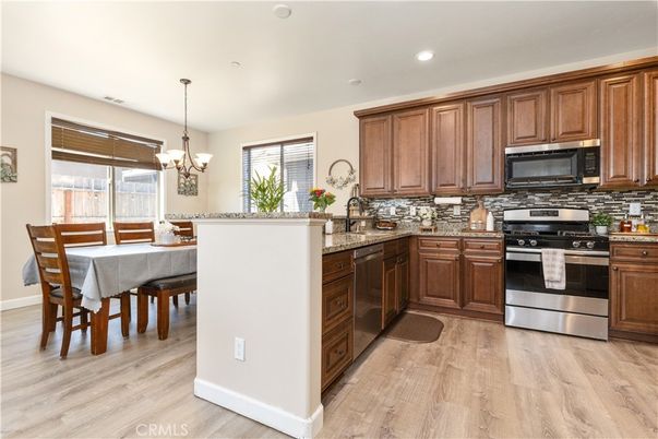 Chandelier, Dining room, Interior, Kitchen, Pendant Lights, Recessed Lighting, Stainless Steel Appliances, Wood Texture Flooring