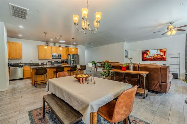 Chandelier, Dining room, Interior, Kitchen, Living room, Pendant Lights, Recessed Lighting, Stainless Steel Appliances, Wood Texture Flooring