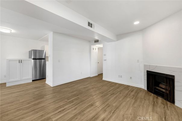 Empty room, Fireplace, Interior, Kitchen, Recessed Lighting, Wood Texture Flooring