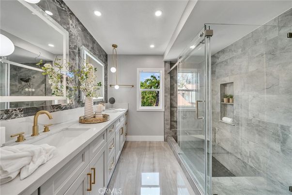 Bathroom, Dual Sink Vanities, Glass Shower, Interior, Marble Walls, Pendant Lights, Recessed Lighting, Wood Texture Flooring