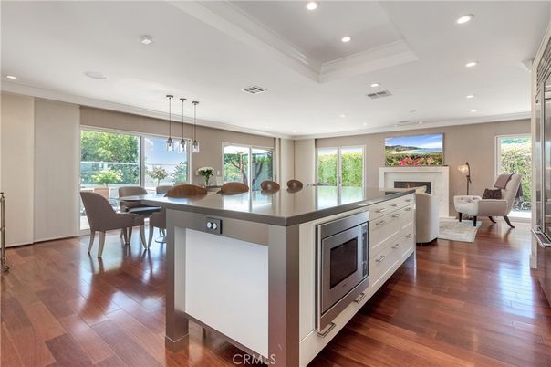 Dining room, Fireplace, Interior, Living room, Pendant Lights, Recessed Lighting, Wood Texture Flooring