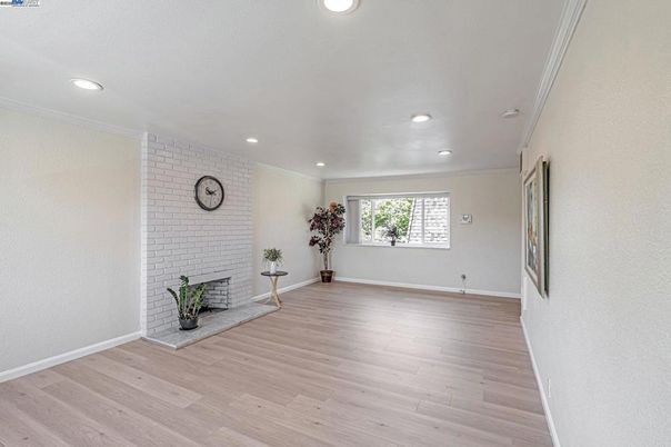 Empty room, Fireplace, Interior, Recessed Lighting, Stone Walls, Wood Texture Flooring