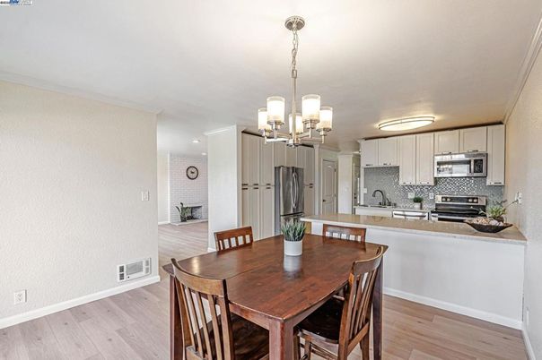 Chandelier, Dining room, Interior, Kitchen, Pendant Lights, Recessed Lighting, Stainless Steel Appliances, Wood Texture Flooring