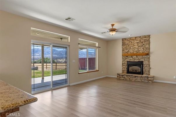 Empty room, Fireplace, Interior, Recessed Lighting, Stone Walls, Wood Texture Flooring