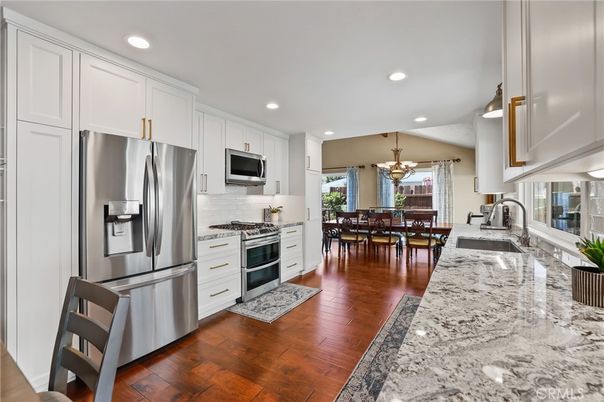 Chandelier, Dining room, Interior, Kitchen, Recessed Lighting, Stainless Steel Appliances, Wood Texture Flooring
