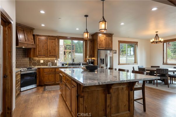 Chandelier, Dining room, Interior, Kitchen, Pendant Lights, Recessed Lighting, Stainless Steel Appliances, Wood Texture Flooring