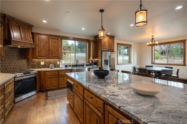 Chandelier, Dining room, Interior, Kitchen, Pendant Lights, Recessed Lighting, Stainless Steel Appliances, Wood Texture Flooring
