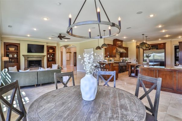 Chandelier, Dining room, Fireplace, Interior, Kitchen, Living room, Pendant Lights, Recessed Lighting, Stainless Steel Appliances