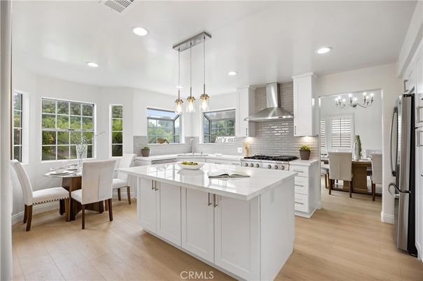 Chandelier, Dining room, Interior, Kitchen, Pendant Lights, Recessed Lighting, Stainless Steel Appliances, Wood Texture Flooring
