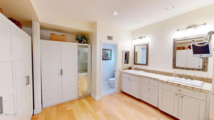 Bathroom, Dual Sink Vanities, Glass Shower, Interior, Recessed Lighting, Tile Countertops, Wood Texture Flooring