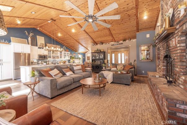 Chandelier, Fireplace, Interior, Kitchen, Living room, Recessed Lighting, Stainless Steel Appliances, Stone Walls, Wooden Beams, Wooden Ceilings, Wood Texture Flooring