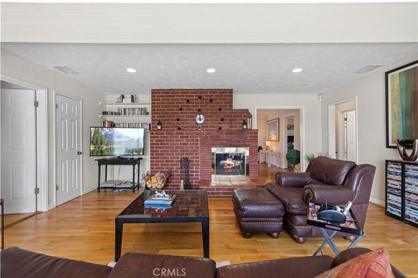 Fireplace, Fitness Equipment, Interior, Living room, Recessed Lighting, Stone Walls, Wood Texture Flooring