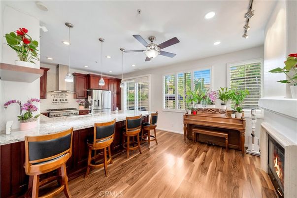 Fireplace, Interior, Kitchen, Pendant Lights, Piano, Recessed Lighting, Stainless Steel Appliances, Wood Texture Flooring