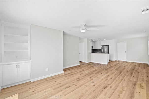 Empty room, Interior, Kitchen, Recessed Lighting, Stainless Steel Appliances, Wood Texture Flooring