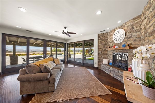 Fireplace, Interior, Living room, Recessed Lighting, Stone Walls, Water, Wood Texture Flooring