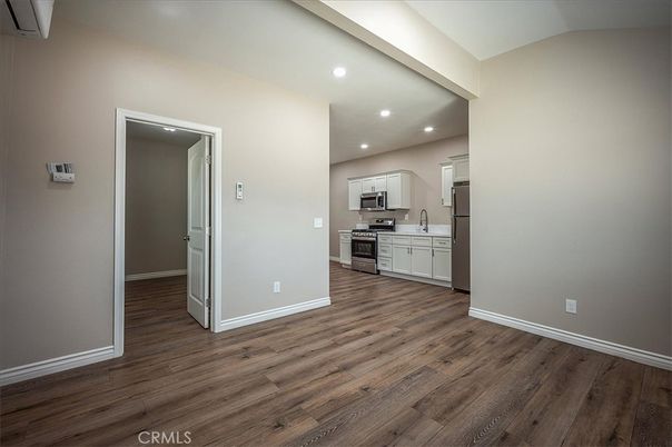 Empty room, Interior, Kitchen, Recessed Lighting, Stainless Steel Appliances, Wood Texture Flooring