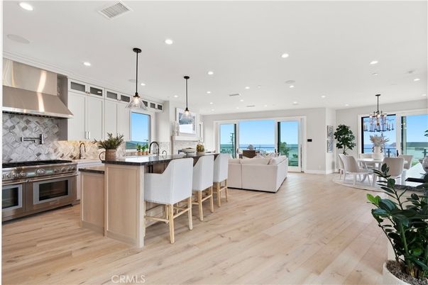 Chandelier, Dining room, Interior, Kitchen, Living room, Pendant Lights, Recessed Lighting, Stainless Steel Appliances, Water, Wood Texture Flooring