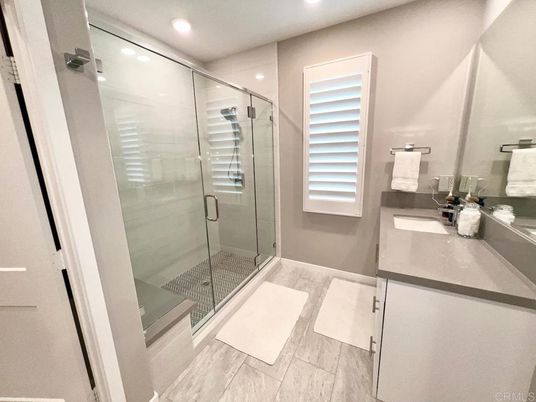 Bathroom, Dual Sink Vanities, Glass Shower, Interior, Recessed Lighting, Wood Texture Flooring