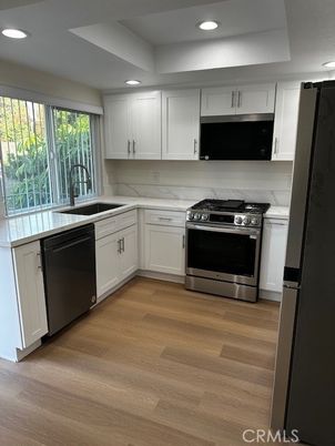 Interior, Kitchen, Marble Walls, Recessed Lighting, Stainless Steel Appliances, Wood Texture Flooring
