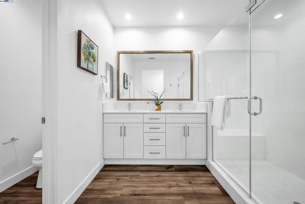 Bathroom, Dual Sink Vanities, Glass Shower, Interior, Recessed Lighting, Wood Texture Flooring