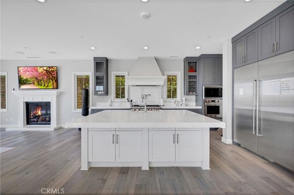 Fireplace, Interior, Kitchen, Recessed Lighting, Stainless Steel Appliances, Wood Texture Flooring