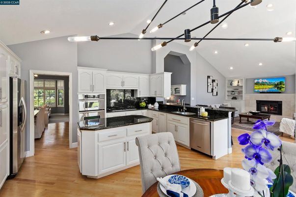 Fireplace, Interior, Kitchen, Living room, Pendant Lights, Recessed Lighting, Stainless Steel Appliances, Wood Texture Flooring