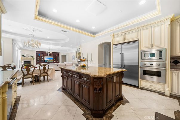 Chandelier, Dining room, Fireplace, Interior, Kitchen, Living room, Recessed Lighting, Stainless Steel Appliances