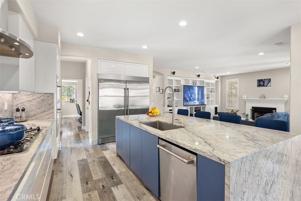Fireplace, Interior, Kitchen, Recessed Lighting, Stainless Steel Appliances, Wood Texture Flooring