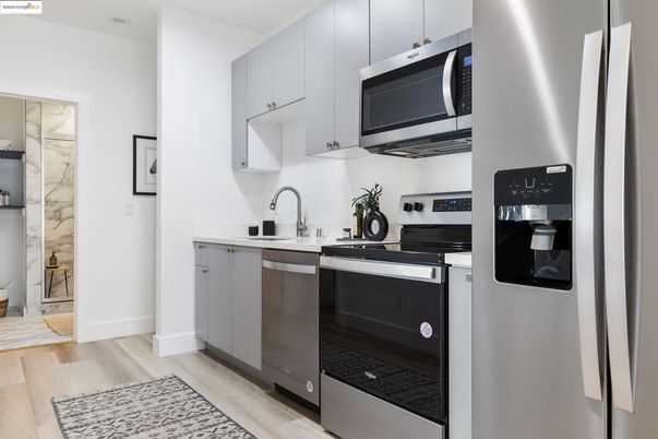 Interior, Kitchen, Marble Walls, Stainless Steel Appliances, Wood Texture Flooring
