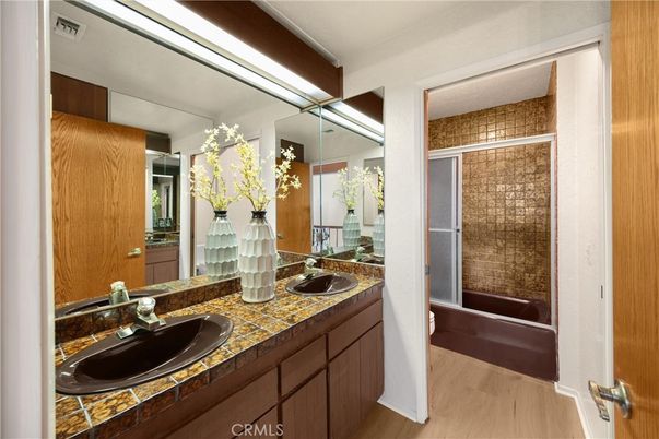 Bathroom, Dual Sink Vanities, Glass Shower, Interior, Tile Countertops, Wood Texture Flooring