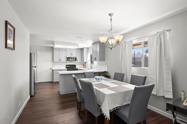 Chandelier, Dining room, Interior, Kitchen, Pendant Lights, Stainless Steel Appliances, Wood Texture Flooring