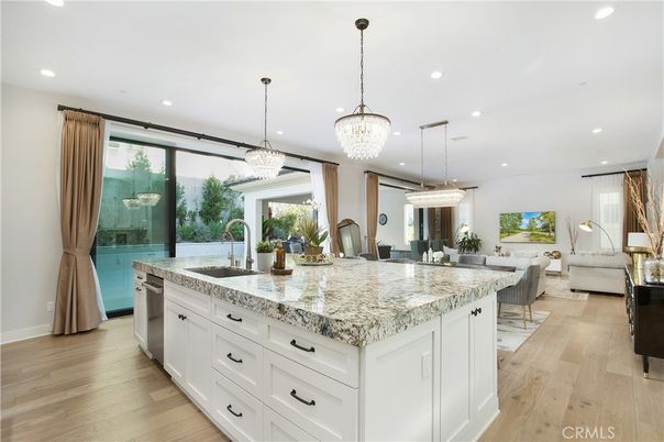 Chandelier, Dining room, Interior, Kitchen, Living room, Pendant Lights, Recessed Lighting, Stainless Steel Appliances, Wood Texture Flooring