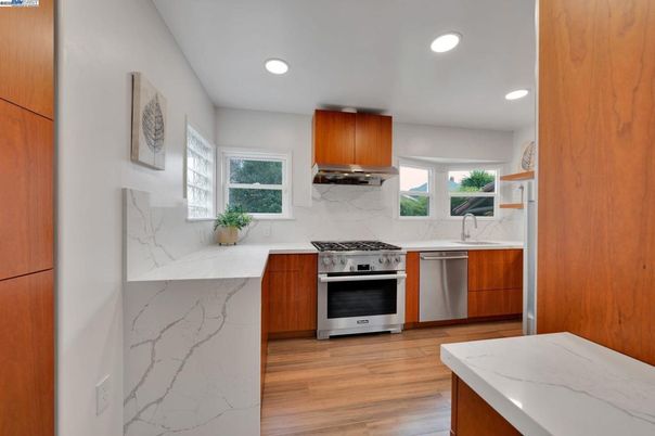 Interior, Kitchen, Marble Walls, Recessed Lighting, Stainless Steel Appliances, Wood Texture Flooring