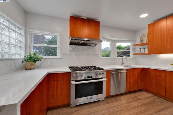 Interior, Kitchen, Marble Walls, Recessed Lighting, Stainless Steel Appliances, Wood Texture Flooring
