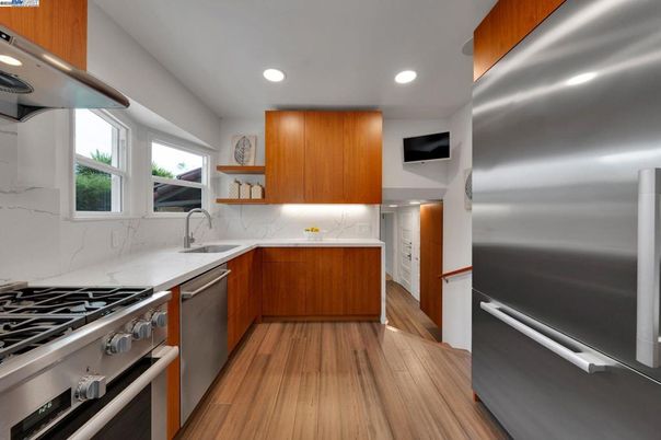 Interior, Kitchen, Marble Walls, Recessed Lighting, Stainless Steel Appliances, Wood Texture Flooring