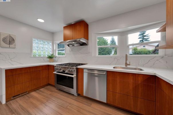 Interior, Kitchen, Marble Walls, Recessed Lighting, Stainless Steel Appliances, Wood Texture Flooring