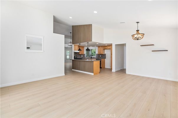Empty room, Interior, Kitchen, Pendant Lights, Recessed Lighting, Stainless Steel Appliances, Wood Texture Flooring