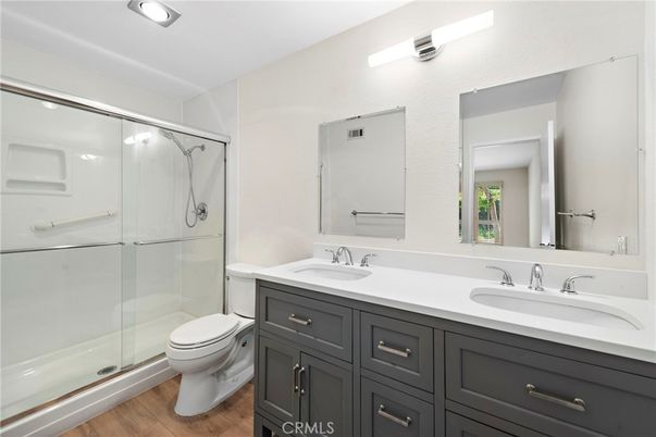 Bathroom, Dual Sink Vanities, Glass Shower, Interior, Recessed Lighting, Wood Texture Flooring