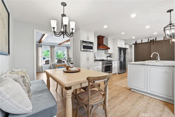 Chandelier, Dining room, Interior, Kitchen, Pendant Lights, Recessed Lighting, Stainless Steel Appliances, Wood Texture Flooring