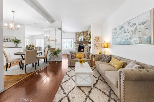 Chandelier, Dining room, Fireplace, Interior, Living room, Pendant Lights, Stone Walls, Wood Texture Flooring