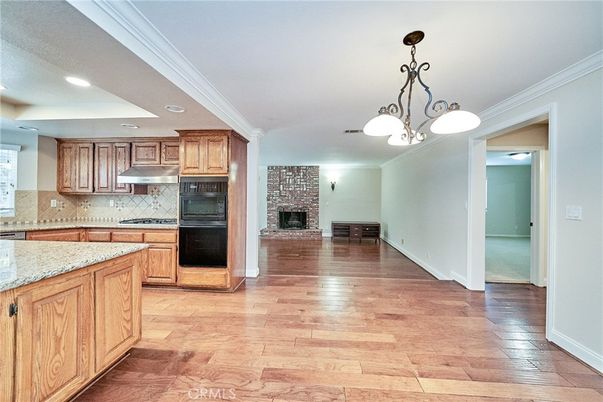 Fireplace, Interior, Kitchen, Pendant Lights, Recessed Lighting, Stone Walls, Wood Texture Flooring
