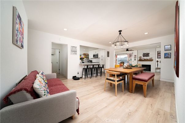 Chandelier, Dining room, Interior, Kitchen, Living room, Pendant Lights, Recessed Lighting, Stainless Steel Appliances, Wood Texture Flooring