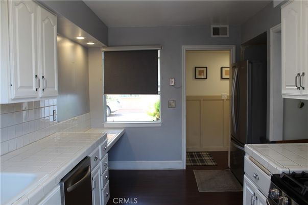 Interior, Kitchen, Recessed Lighting, Tile Countertops, Wood Texture Flooring